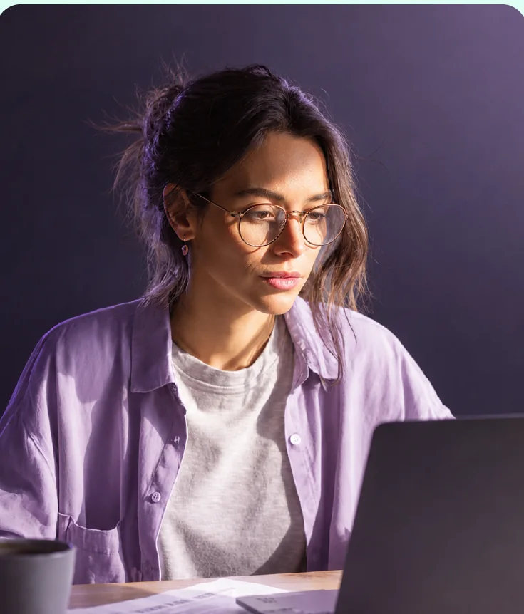 The Adaptd founder working in warm violet light